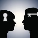 constructive confrontation: silhouette of two heads, one with lock and one with key
