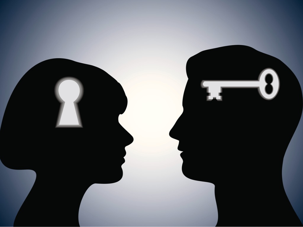 constructive confrontation: silhouette of two heads, one with lock and one with key